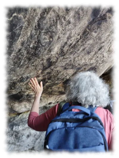 A pilgrim touching the grotto wall Lourdes